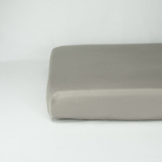 End of mattress with organic cotton fitted cot sheet in sleet grey