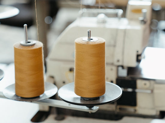 The best sheet thread count? Honey gold cotton reels set up on sewing machines ready to be used to sew bedding