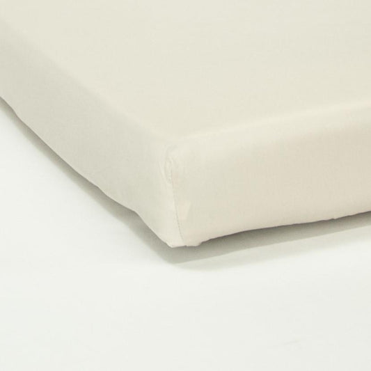 Corner of mattress with organic cotton fitted cot sheet in egg shell white