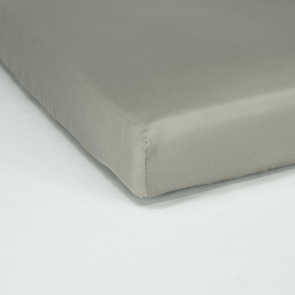 Corner of mattress with organic cotton fitted cot sheet in sleet grey