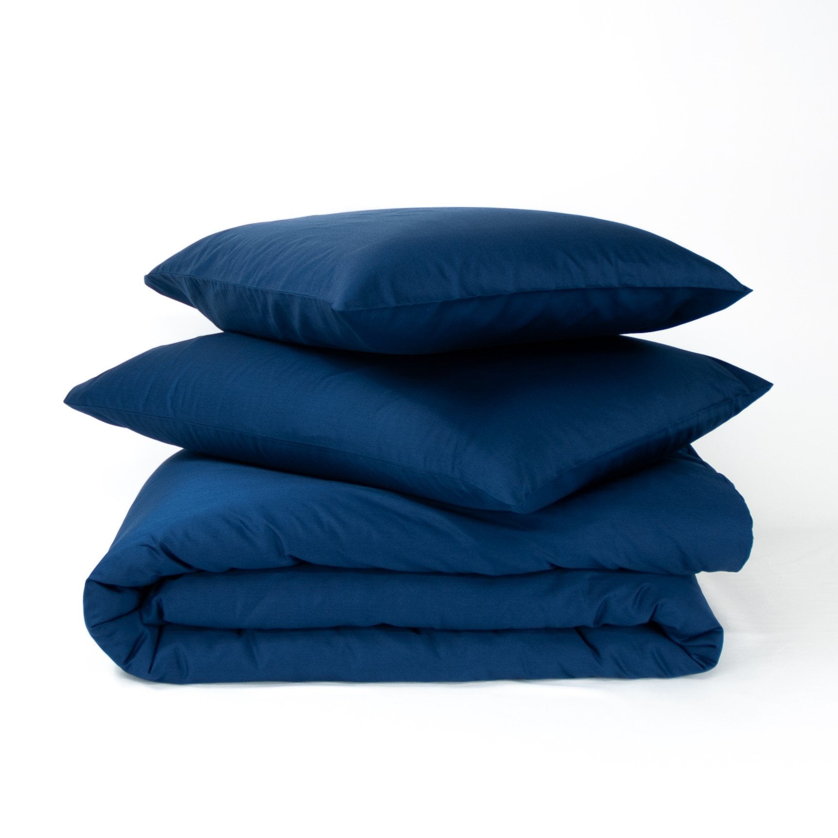 Stack of organic cotton quilt cover set with pillowcases and folded quilt cover in classic blue