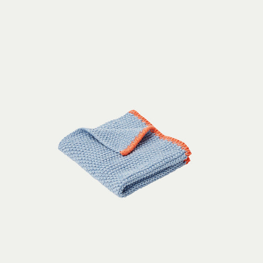 Hubsch Interior Scandi designer dish cloth in blue and orange cotton knit on a white background