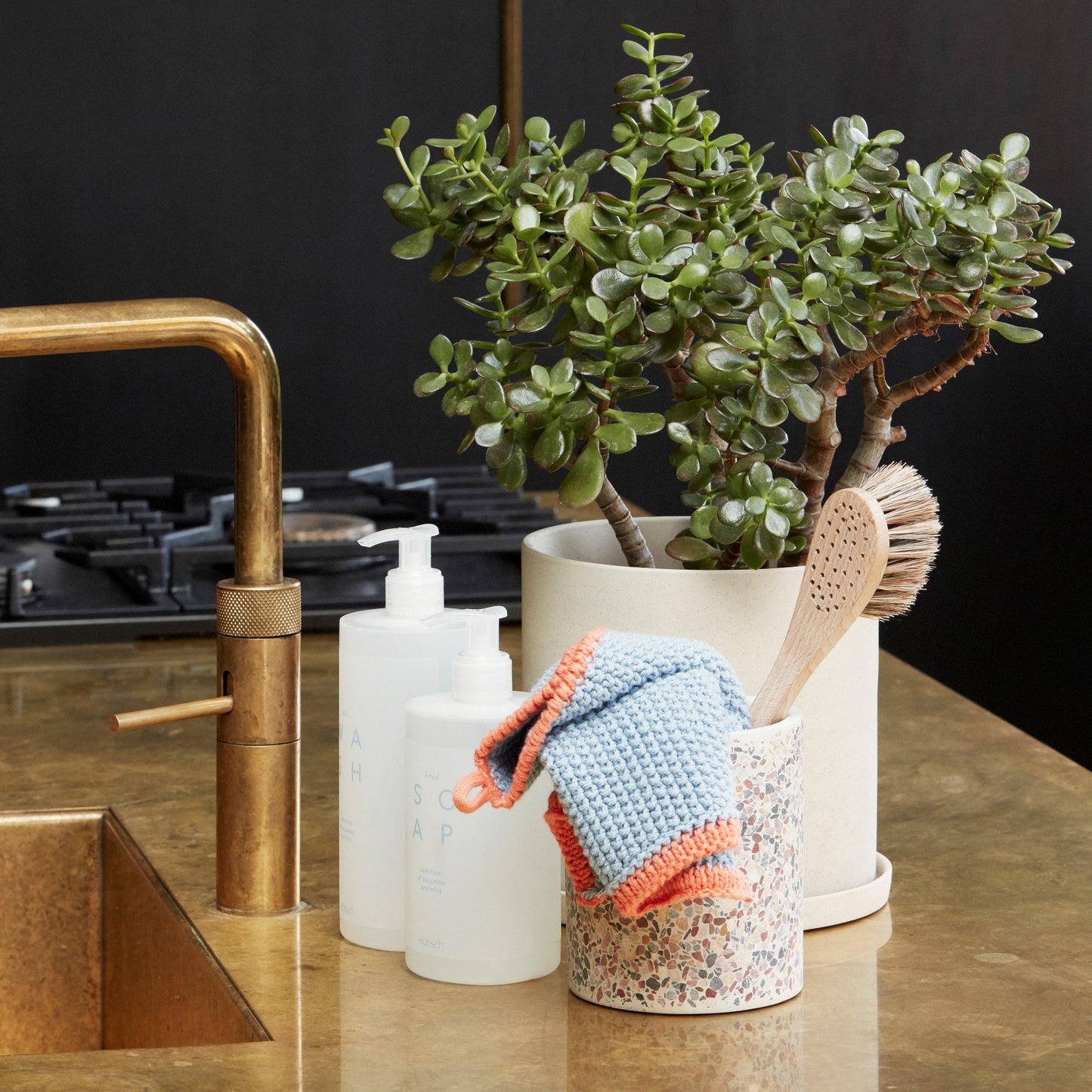 Hubsch Interior Scandi designer dish cloth in blue and orange cotton knit in a cup on a kitchen bench