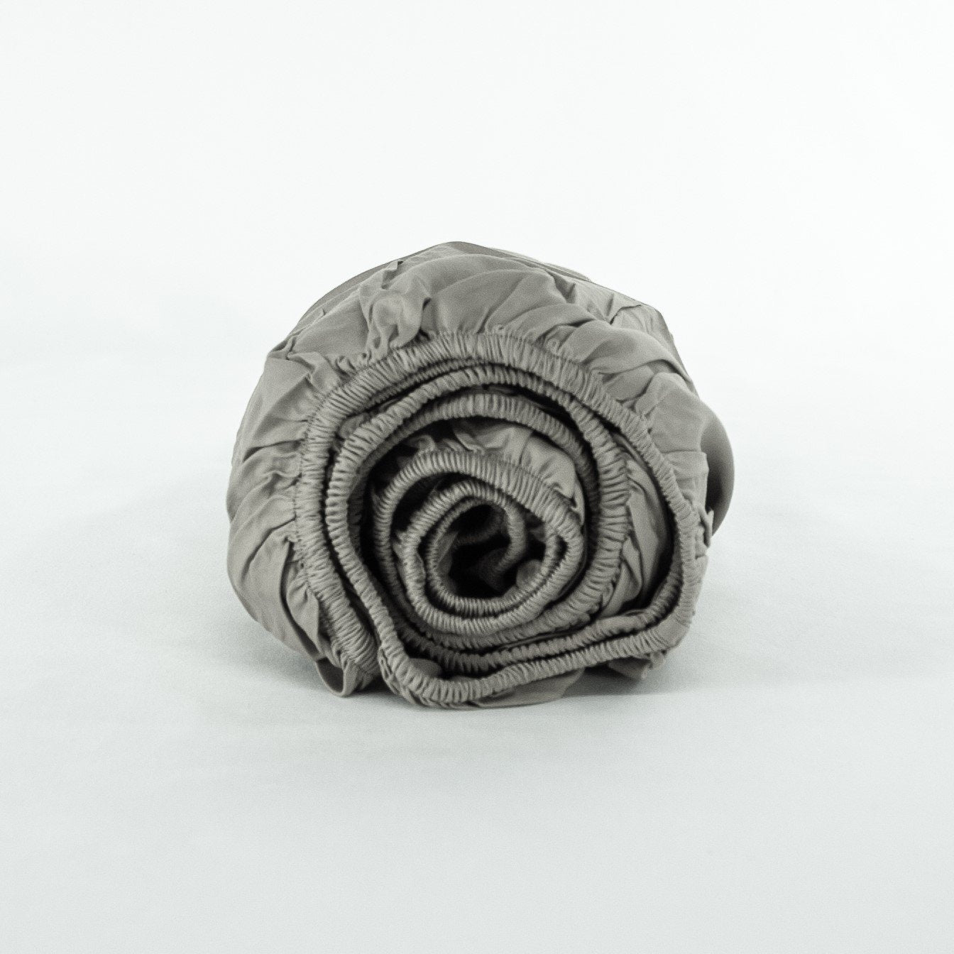 Rolled up organic cotton fitted sheet in sleet grey