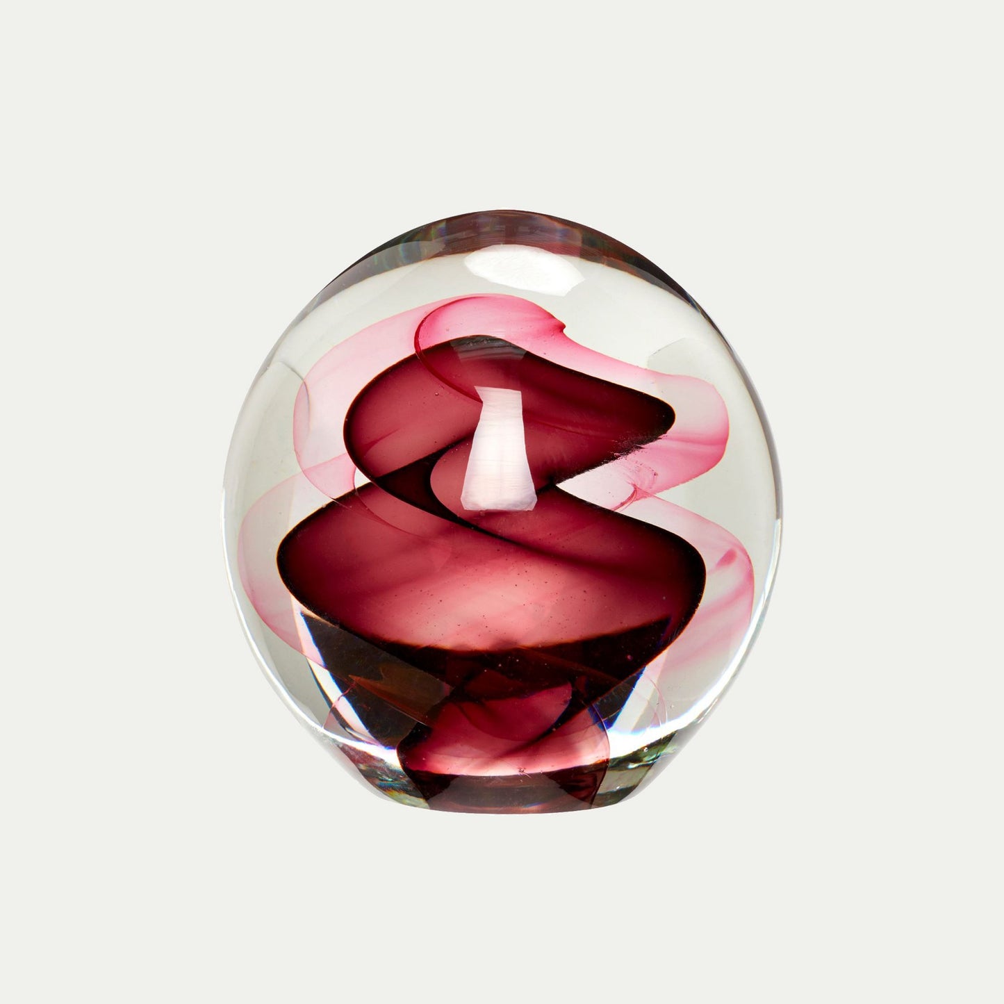 Hubsch Interior objet d’art paperweight in burgundy red and pink swirl pattern on white background