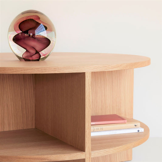 Hubsch Interior objet d’art paperweight in burgundy red and pink swirl pattern on coffee table with books