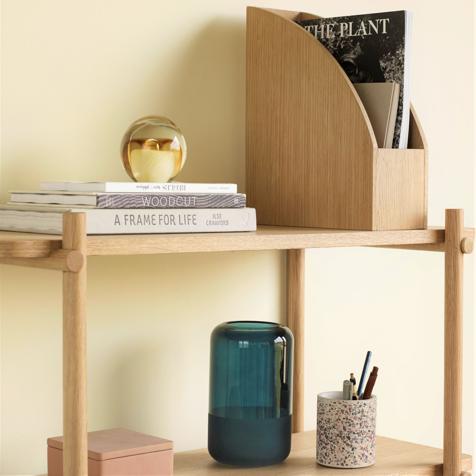 Hubsch Interior objet d’art paperweight in honey amber and cream on bookshelf with books