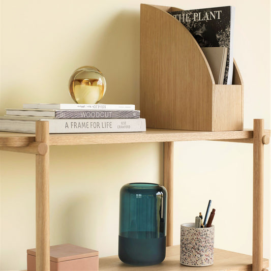 Hubsch Interior objet d’art paperweight in honey amber and cream on bookshelf with books