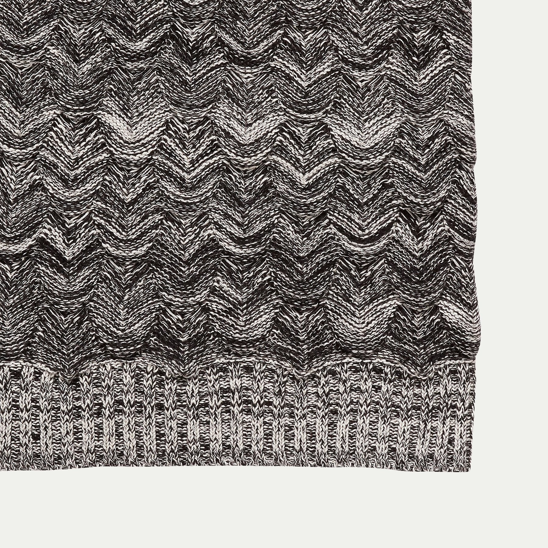 Close up of a Hubsch Interior large cotton scale knit throw blanket in charcoal grey and cream on white background