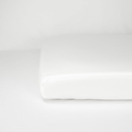 End of mattress with organic cotton fitted cot sheet in pure white