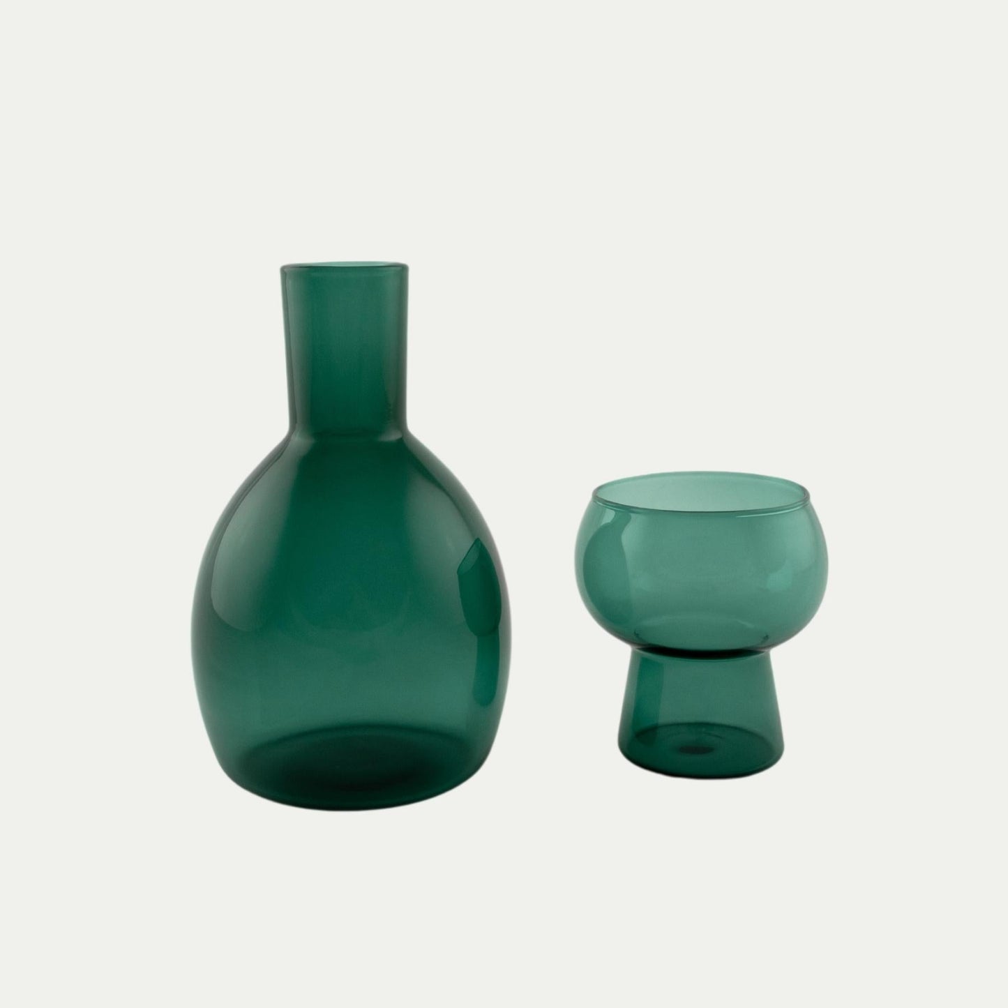 Coco and Henry Marnie carafe and stemless wine glass side by side, teal green coloured, made from borosilicate glass