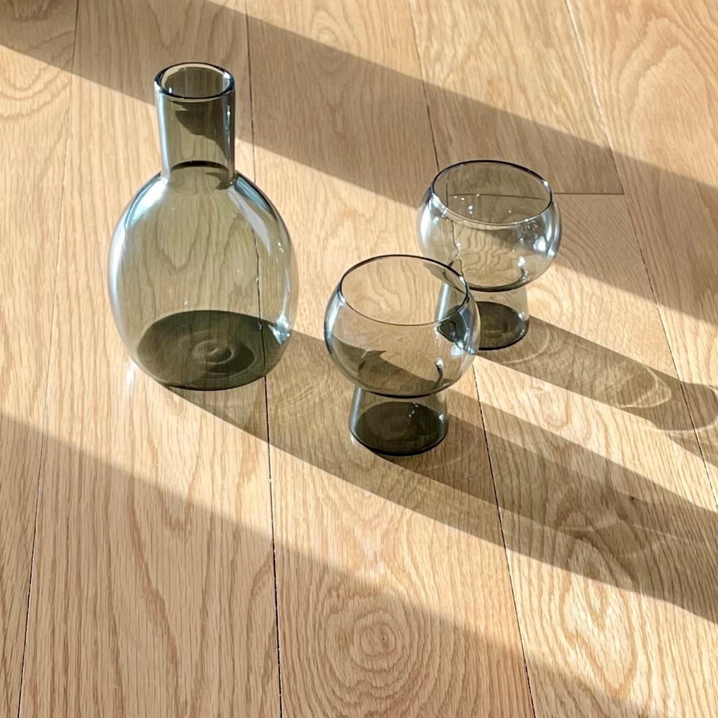 Marnie smoke grey carafe and glasses on wooden floor in sinlight